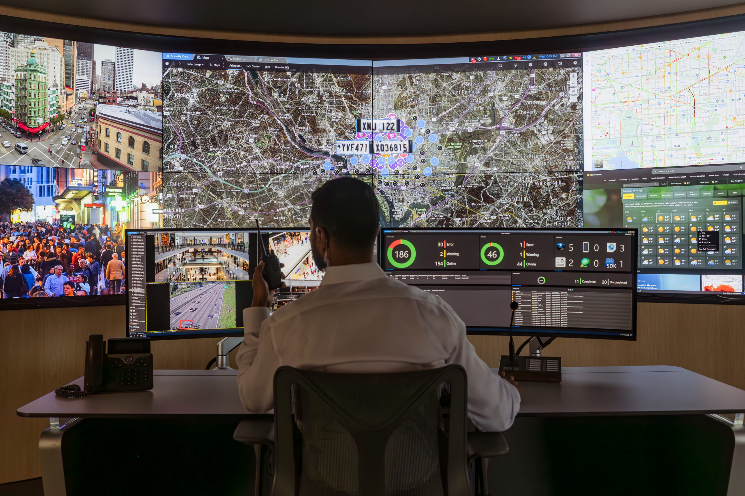 Image of a technician monitoring building equipment with connected technology.