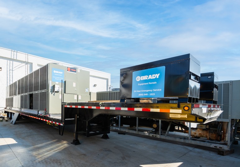 Image of a technician monitoring building equipment with connected technology.