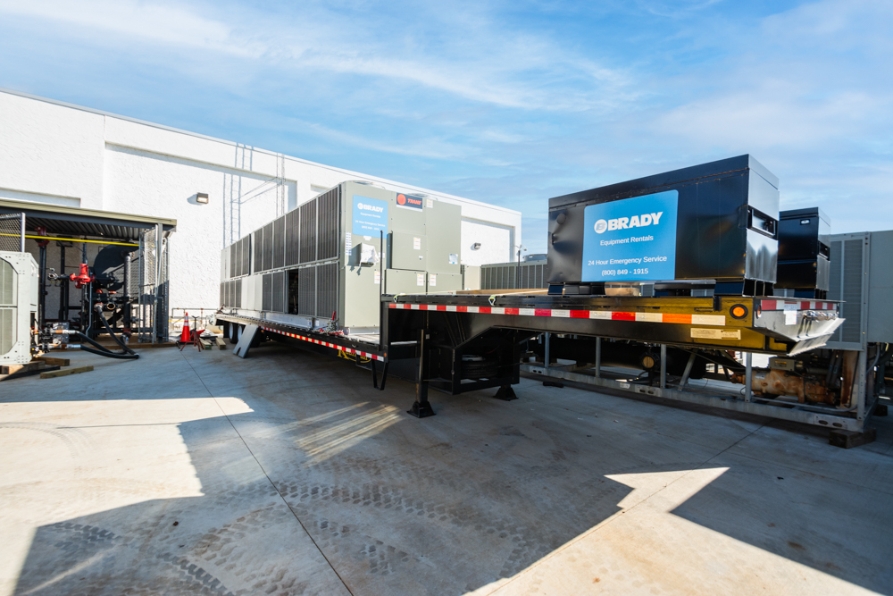 Image of a technician monitoring building equipment with connected technology.